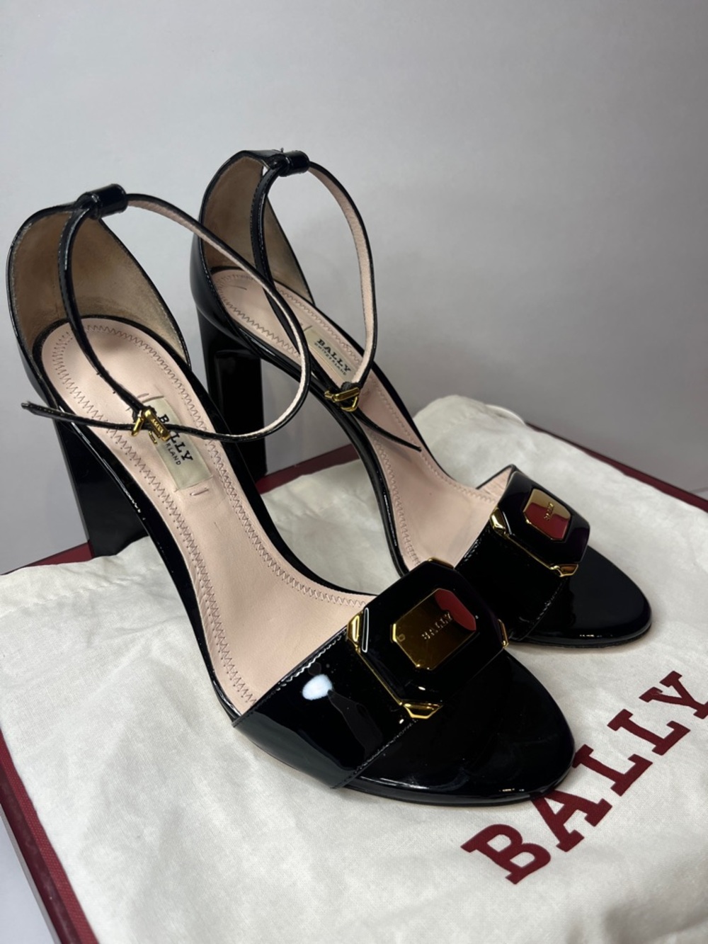 Bally Black Patent Leather Ankle-Strap Heeled Sandals with Gold Plaque
